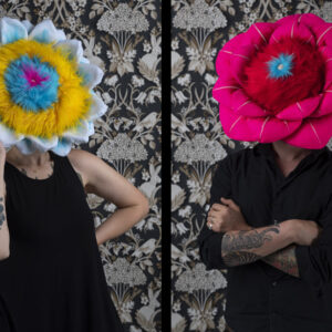 Ryan Lytle and Kristin Skees wear fiber flowers on their heads
