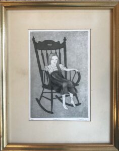 Picture of a young girl in a rocking chair. It is an etching by artist Carolyn Flowers