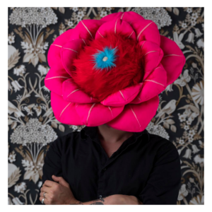 Ryan Lytle Newport News Artist standing with a fiber flower on his head